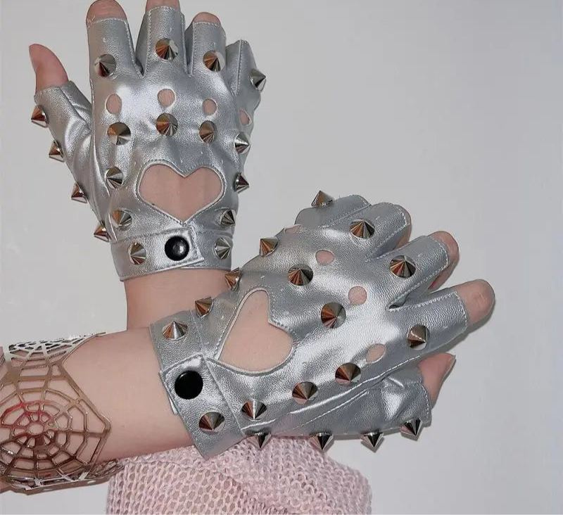 Silver studded gloves with heart designs on a plain background
