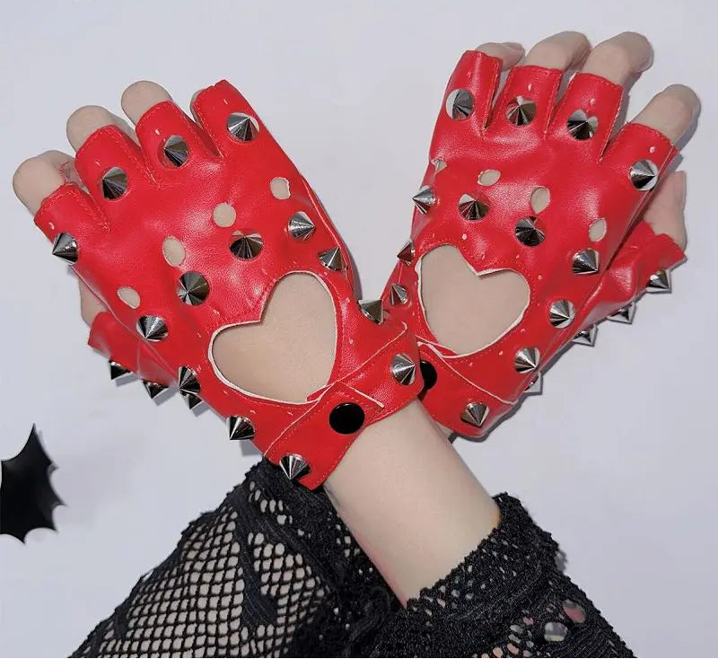 Red gloves with heart designs and studs held against a white background.